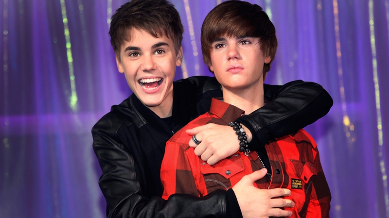 Canadian musician Justin Bieber hugs the new waxwork figure of himself at Madame Tussaud's in London, Tuesday, March. 15, 2011. (AP / Joel Ryan)