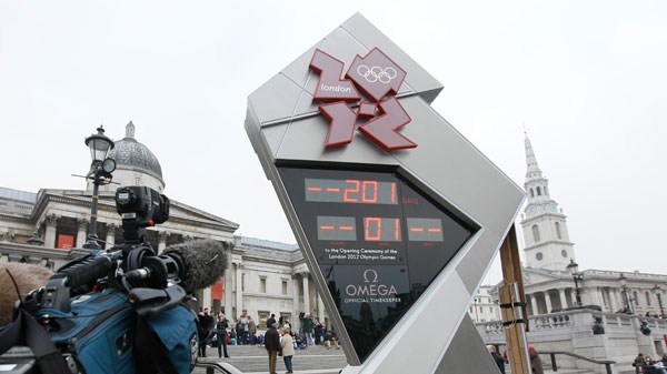 The official London 2012 Olympic countdown clock is attended to by technicians hours after it was started in Trafalgar Square in London, Tuesday March 15, 2011. (AP / Alastair Grant)