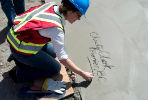 BC Liberal leader Christy Clark signs her name in concrete as she tours Babine Forest Products mill site in Burns Lake, B.C. Thursday, May 9, 2013. British Columbians will go to the polls May 14th. (THE CANADIAN PRESS/Jonathan Hayward)