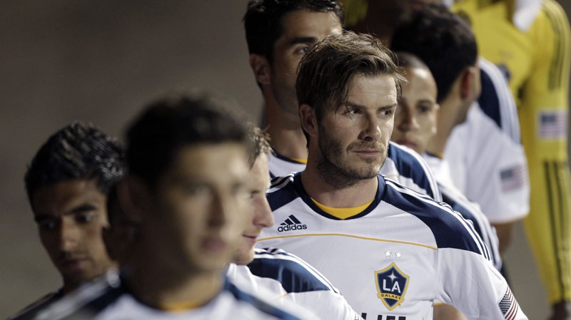 Los Angeles Galaxy's David Beckham, right, lines up to take the field with his team for an exhibition soccer match against Club Tijuana on Wednesday, March 2, 2011, in San Diego. (AP Photo/Gregory Bull)
