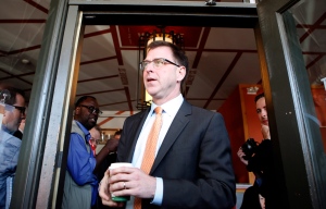 NDP B.C. Leader candidate Adrian Dix holds his coffee as he walks out to supporters during the leader's tour at the Village Cafe' in Oak Bay during the British Columbia election campaign in Victoria, B.C. Friday, May 10, 2013. (THE CANADIAN PRESS/Chad Hipolito)