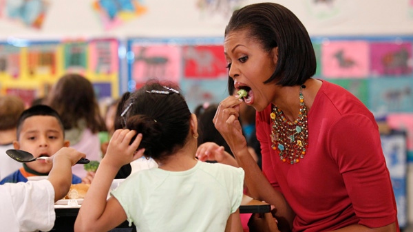 First lady Michelle Obama eats a piece of broccoli as she sits down to eat with students during a visit to New Hampshire Elementary School in Silver Spring, Md., on Wednesday, May 19, 2010. (AP / Pablo Martinez Monsivais)