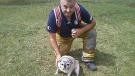 Dexter poses with the fire fighter who saved him from a blaze at a Stony Plain apartment Thursday.
