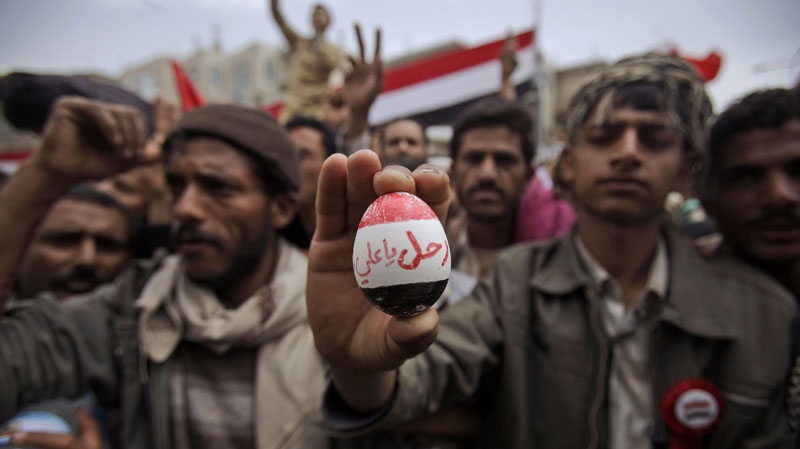 An anti-government protestor displays an egg that reads in arabic, " Leave Ali", during a demonstration demanding the resignation of Yemeni President Ali Abdullah Saleh, in Sanaa, Yemen, Wednesday, March 16, 2011. (AP Photo/Muhammed Muheisen)