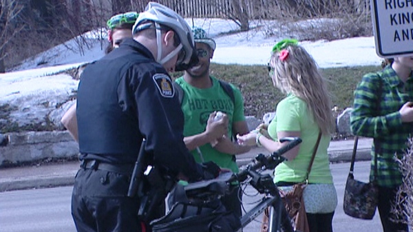 Police issue tickets to St. Patrick's day revellers in Waterloo, Ont. on Thursday, March 17, 2011.