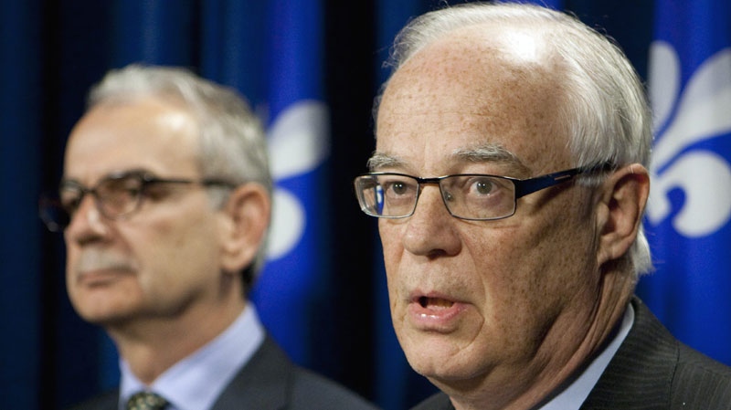 Quebec Public Security Minister Robert Dutil, right, announces the nomination of Robert Lafreniere, left, as anti-corruption unit commissary Wednesday, March 16, 2011, at the legislature in Quebec City. (THE CANADIAN PRESS/Jacques Boissinot)