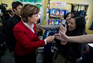 A woman, right, reacts as she meets B.C Premier and Liberal Leader Christy Clark during a campaign stop at Teng's Market in Vancouver, B.C., on Monday May 13, 2013. (Darryl Dyck / THE CANADIAN PRESS)