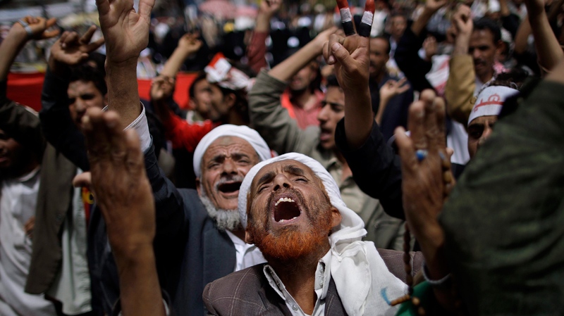 An anti-government protestor raises his hands up as he chants prayers during a demonstration demanding the resignation of Yemeni President Ali Abdullah Saleh, in Sanaa, Yemen, Wednesday, March 16, 2011. (AP / Muhammed Muheisen)