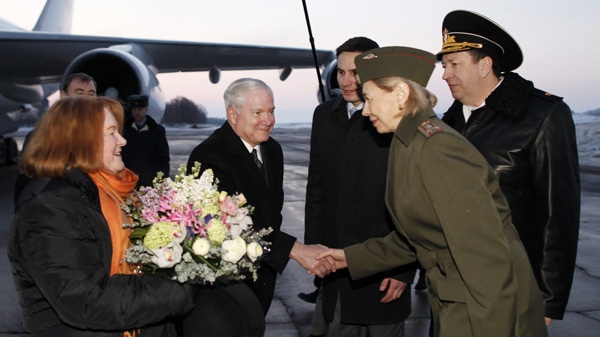 U.S. Defense Secretary Robert Gates, center, and his wife Becky, left, are greeted upon their arrival in St. Petersburg, Russia, Monday, March 21, 2011. (AP Photo/Charles Dharapak, Pool)