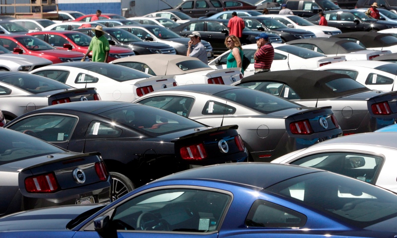 Potential new car buyers look through the Galpin Ford dealership lot in Los Angeles in this Aug. 24, 2009 file photo. (AP / Nick Ut)
