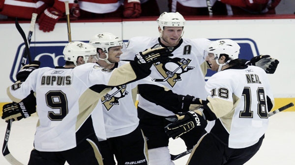Pittsburgh Penguins' James Neal (18) celebrates with teammates, from left, Pascal Dupuis (9), Chris Kunitz and Jordan Stall after scoring the only goal in a shootout, giving the Penguins a 5-4 win over the Detroit Red Wings in an NHL hockey game Monday, March 21, 2011, in Detroit. (AP Photo/Duane Burleson)