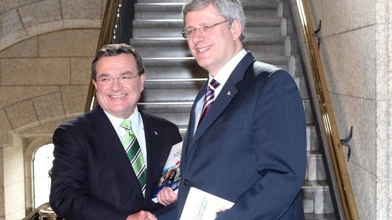 Finance Minister Jim Flaherty and Prime Minister Stephen Harper shake hands as they make their way to the House of Commons to deliver the federal budget on Parliament Hill in Ottawa on Tuesday March 22, 2011. (Fred Chartrand / THE CANADIAN PRESS)