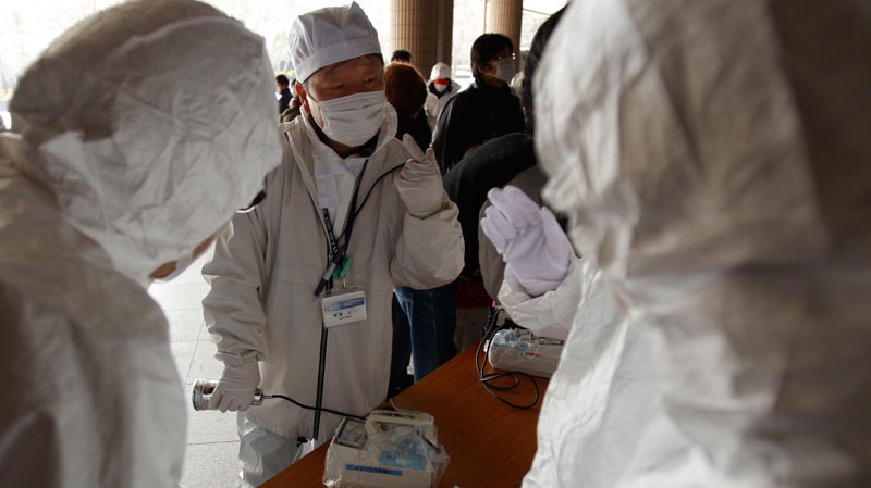 Volunteers are taught how to screen evacuees at a shelter for leaked radiation from the damaged Fukushima nuclear plant, Thursday, March 24, 2011 in Fukushima, Japan. (AP / Wally Santana)