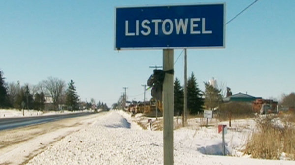 A black bow is tied to the Listowel, Ont., sign as a tribute to two fallen firefighters on Thursday, March 24, 2011.