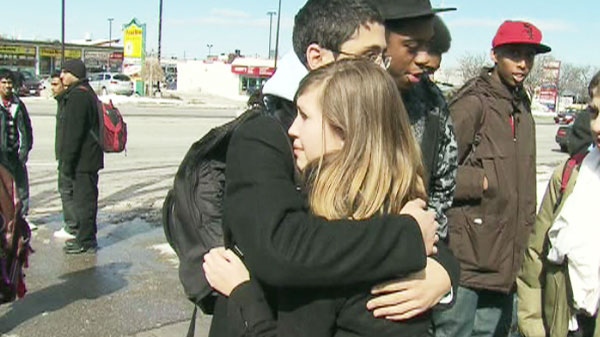 Students from Winston Churchill Collegiate Institute embrace after the lockdown was lifted on Thursday, March 24, 2011.
