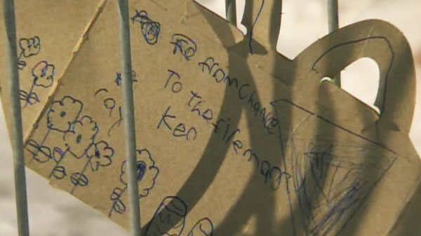 A hand-written card is left by the scene of a fatal fire in Listowel, Ont., on Thursday, March 24, 2011.