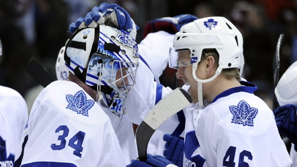 Toronto Maple Leafs right wing Joey Crabb (46) congratulates goaltender James Reimer (34) following an NHL hockey game against the Colorado Avalanche on Thursday, March 24, 2011, in Denver. Toronto beat Colorado 4-3. (AP Photo/Jack Dempsey) 