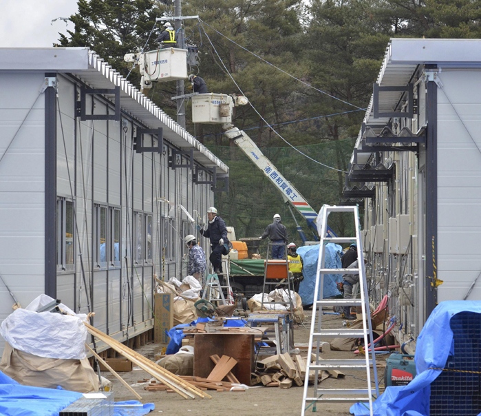 A temporary housings are being built on the school ground of Takata Dai-ichi Junior High School which is converted into a tsunami-evacuation centre in Rikuzentakata, Iwate prefecture, Saturday, March 26, 2011. (Yomiuri Shimbun / Tetsu Joko)