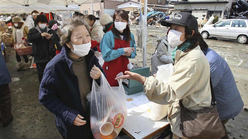 Tsunami survivors shop at an open-air market in the town of Yamada in Iwate Prefecture Sunday, March 27, 2011. (AP / The Yomiuri Shimbun, Tetsuya Kikumasa)