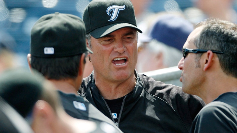 Toronto Blue Jays head coach John Farrell, centre, talks with his first base coach Torey Lovullo, right, while facing the Tampa Bay Rays in a spring training baseball game in Port Charlotte, Fla., Tuesday, March 8, 2011. (AP / Charles Krupa)