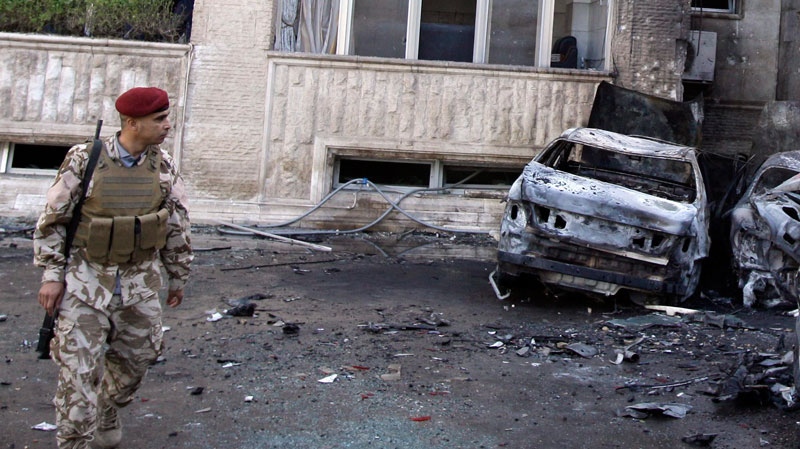 An Iraqi soldier inspects the scene of a rocket attack in Baghdad, Iraq, Tuesday, March, 29, 2011.  (AP / Karim Kadim)
