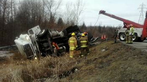 Firefighters respond to a tractor trailer rollover on the Queensway at the Walkley Road exit, Tuesday, March 29, 2011.