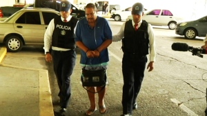 A frail-looking Arthur Porter is seen being transported by Panama police officers in a photo supplied by the force Thursday afternoon. 