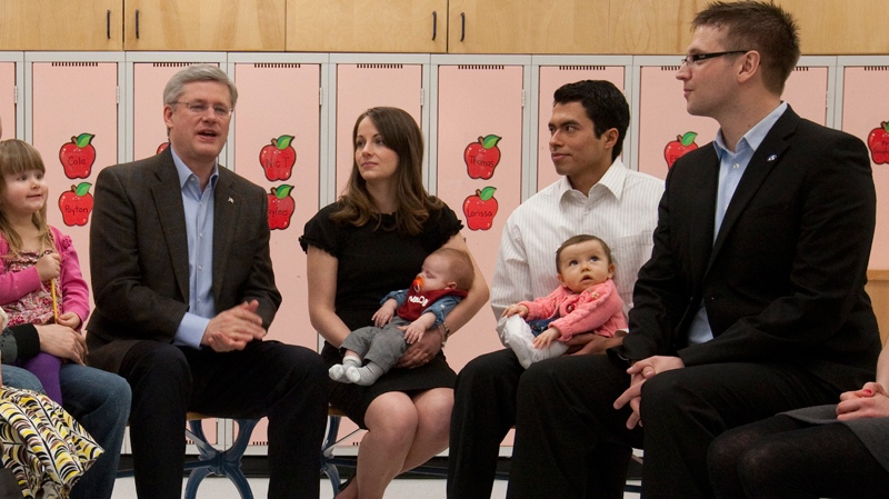 Conservative Leader Stephen Harper talks with Conservative candidate for Edmonton - Strathcona Ryan Hastman (right) and other parents during a roundtable in Beaumont, Alta., Monday, March 28, 2011. (Adrian Wyld / THE CANADIAN PRESS)  