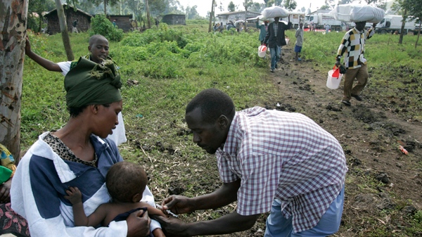 A health worker vaccinates a child against measles in a camp for displaced people in Kibati, north of Goma in eastern Congo on Sunday, Nov. 16, 2008. (AP / Karel Prinsloo)
