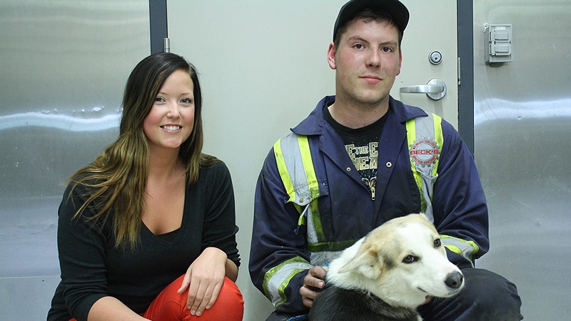 Parkland County employee Mackenzie Blackburn (L), poses with Glenn Arcand and his dog Diego in a photo posted on the Parkland County Animal Shelter's website Friday, May 31. Courtesy: Facebook