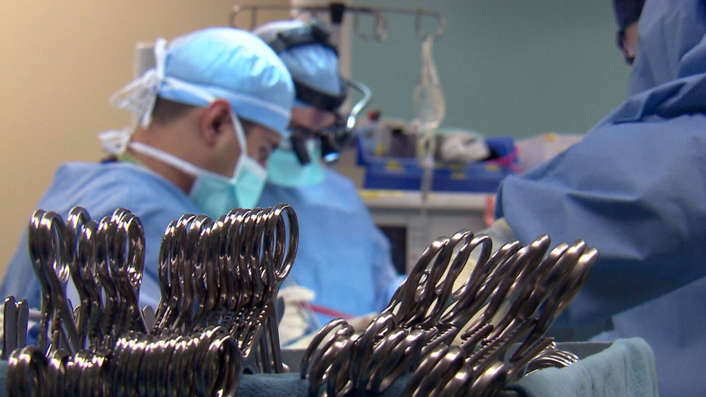 Doctors in operating room, organ transplant