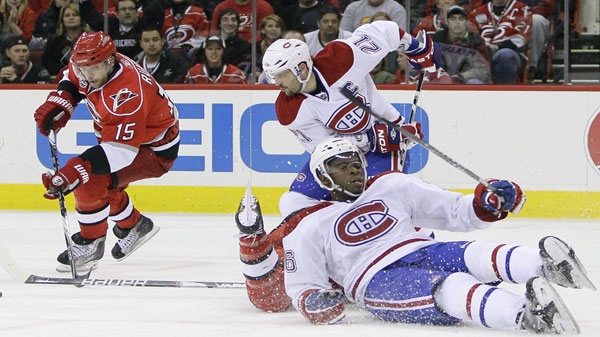 Carolina Hurricanes' Tuomo Ruutu (15), of Finland, controls the puck as Montreal Canadiens' Brian Gionta (21) chases and P.K. Subban falls to the ice during the second period of an NHL hockey game in Raleigh, N.C., Wednesday, March 30, 2011. (AP Photo/Gerry Broome)