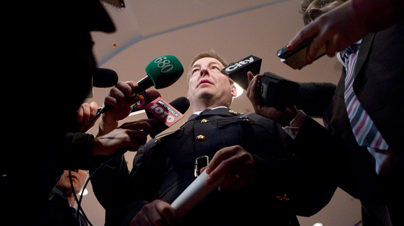 Inspector Keith Finn (right) of the RCMP's  Integrated National Security Enforcement Team (INSET) scrums withe the media following a press conference in Toronto on Thursday March 30, 2011 relating to the arrest of Mohamed Hersi. (Chris Young / THE CANADIAN PRESS)