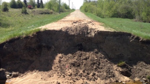 A washed-out section in the RM of Hillsburg, near Roblin, Manitoba, is shown on Road 150 West near Highway 5. One man died after his vehicle went into it.