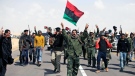 Libyan rebels shout slogans as they hear about air strikes at front line near Brega, Libya, Friday, April 1, 2011. (AP / Altaf Qadri)