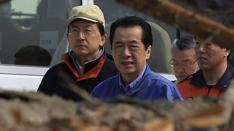 Japanese Prime Minister Naoto Kan, center, walks past the rubble in front of municipal building Saturday, April 2, 2011 in Rikuzentakata, Iwate Prefecture, northern Japan. (AP Photo/Eugene Hoshiko)
