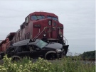 A Ford Explorer was crushed as it collided with a freight train on Wallace Line Road in Lakeshore, Ont., on Thursday, June 6, 2013. (Gina Chung / CTV Windsor) 