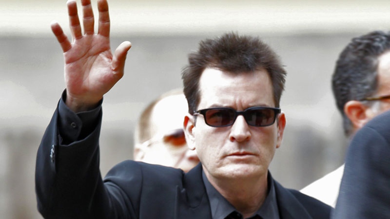 In a Aug. 2, 2010 file photo, Charlie Sheen waves as he arrives at the Pitkin County Courthouse in Aspen, Colo., for a hearing in his domestic abuse case. (AP Photo/Ed Andrieski)