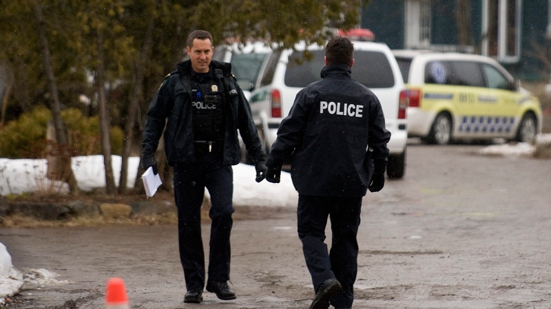 Police officers stand at the scene where Adam Benhamma went missing, in Laval, Que., near Montreal, Monday, April 4, 2011. (Graham Hughes / The CANADIAN PRESS)  
