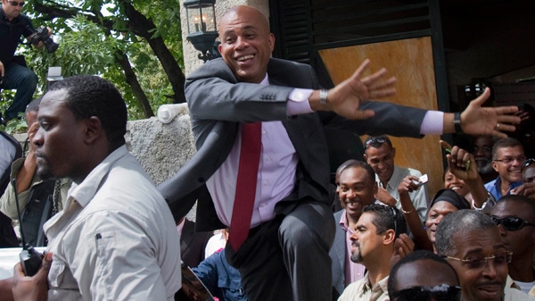 Haiti's presidential candidate Michel 'Sweet Micky' Martelly greets supporters after giving a press conference in Port-au-Prince, Haiti, Tuesday April 5, 2011. (AP / Dieu Nalio Chery)