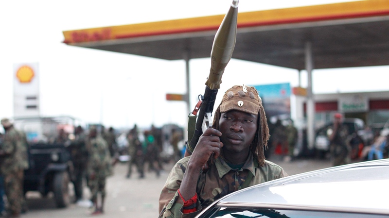Soldiers loyal to Alassane Ouattara rest at a gas station in the Youpougon neighborhood, at the main northern entrance to Abidjan, Ivory Coast, Tuesday, April 5, 2011. (AP / Rebecca Blackwell)