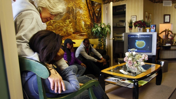 Linda Marzulla, far left, a pregnancy counselor, consoles a client during the presentation of a video about pre-natal development on Wednesday, March 23, 2011 at the EMC Pregnancy Center, in Brooklyn, N.Y. (AP Photo/Bebeto Matthews)