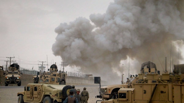 Smoke billows from a police compound after it was attacked by insurgents in Kandahar, south of Kabul, Afghanistan on Thursday, April 7, 2011. (AP / Khalid Sial)
