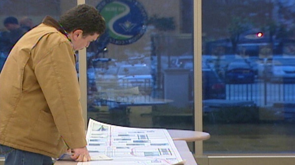 A resident looks at Waterloo Region's rapid transit plans at a public consultation in Kitchener, Ont. in Feb. 2011.