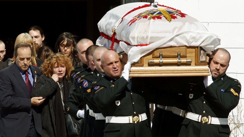 The casket bearing Cpl. Yannick Scherrer is carried out of the church following funeral services, as his father Guy Scherrer, left, and his mother Josee Belisle, second left, look on in CFB Valcartier on Friday April 8 2011. (Clement Allard / THE CANADIAN PRESS)