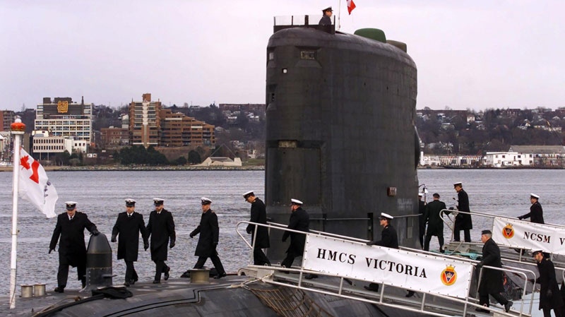 The crew of HMCS Victoria, Canada's first Victoria-class submarine, board the ship during commissioning ceremonies in Halifax on Dec. 2, 2000. (Andrew Vaughan / THE CANADIAN PRESS)
