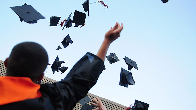 New graduate throws hat into air