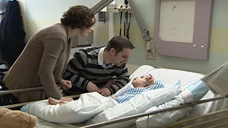 Parents Katy and Jimmy Ruggiero stand by the bed of their son Luca, recovering from injuries sustained in a car crash.