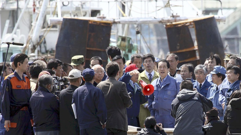 Japan's Prime Minister Naoto Kan, center right, visits a port in Ishinomaki, which was devastated by last month's tsunami Sunday, April 10, 2011. (AP / Yomiuri Shimbun, Hiroto Sekiguchi) 