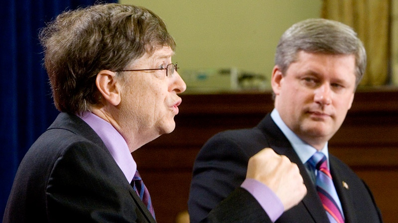 Bill Gates answers reporters questions in Ottawa Feb. 20, 2007 as Canadian Prime Minister Stephen Harper looks on following their announcement for funding to support the Canadian HIV Vaccine Initiative. (Tom Hanson / THE CANADIAN PRESS)